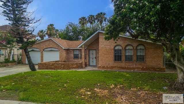 115 E Armstrong Ct, Brownsville, TX 78521 - single story home with brick siding, a garage, a front yard, and concrete driveway