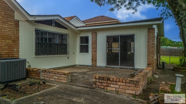 115 E Armstrong Ct, Brownsville, TX 78521 - doorway to property with central air condition unit, brick siding, and a patio area