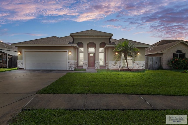 7136 Arroyo Blvd, Brownsville, TX 78526 - mediterranean / spanish house with stucco siding, driveway, a garage, and stone siding