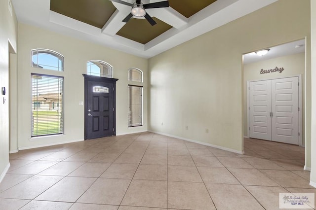 7136 Arroyo Blvd, Brownsville, TX 78526 - entryway with coffered ceiling, ceiling fan, light tile patterned flooring, baseboards, and beam ceiling