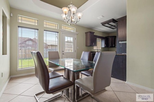 7136 Arroyo Blvd, Brownsville, TX 78526 - dining room featuring baseboards, a chandelier, light tile patterned floors, and plenty of natural light