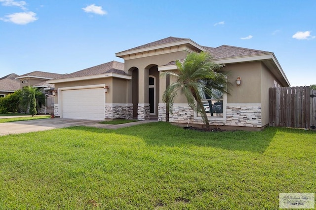 7136 Arroyo Blvd, Brownsville, TX 78526 - mediterranean / spanish home with stone siding, stucco siding, an attached garage, and concrete driveway