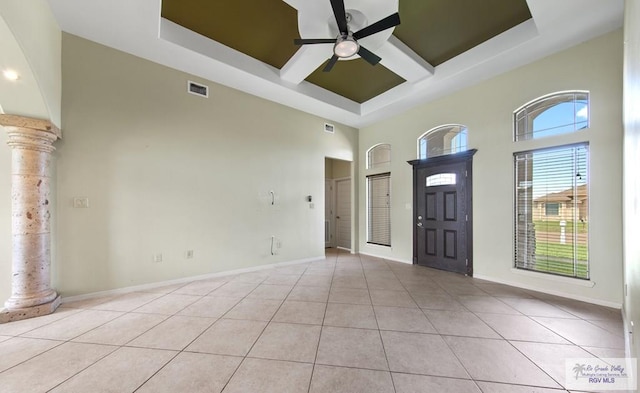 7136 Arroyo Blvd, Brownsville, TX 78526 - entryway featuring a raised ceiling, a towering ceiling, ceiling fan, ornate columns, and light tile patterned floors