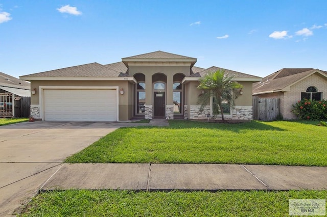 7136 Arroyo Blvd, Brownsville, TX 78526 - mediterranean / spanish home featuring stucco siding, an attached garage, concrete driveway, and stone siding