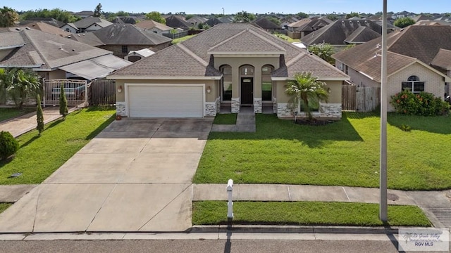 7136 Arroyo Blvd, Brownsville, TX 78526 - view of front of house with stucco siding, stone siding, a garage, concrete driveway, and a residential view