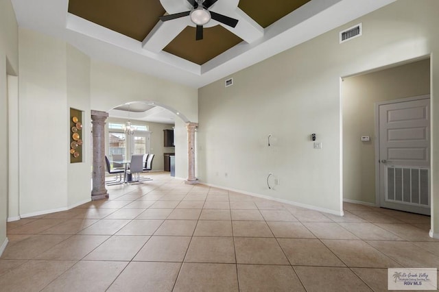 7136 Arroyo Blvd, Brownsville, TX 78526 - tiled spare room featuring ornate columns, arched walkways, coffered ceiling, a ceiling fan, and a high ceiling