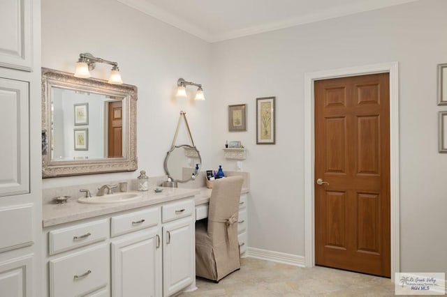 bathroom featuring crown molding, vanity, and baseboards