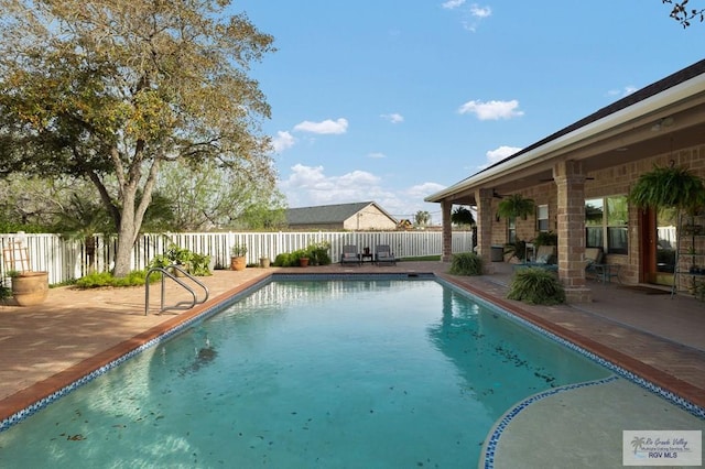 view of swimming pool with a patio area, fence, and a fenced in pool