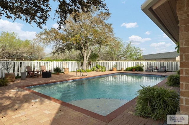 view of pool with a patio area, fence, and a fenced in pool