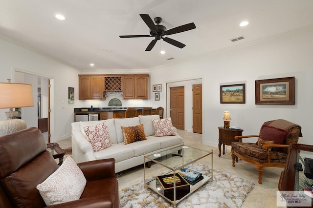 living room featuring indoor wet bar, visible vents, and recessed lighting