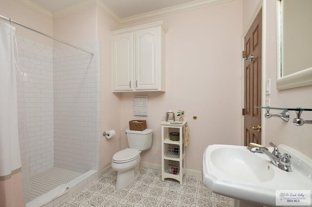 full bathroom with toilet, crown molding, a sink, and a shower stall