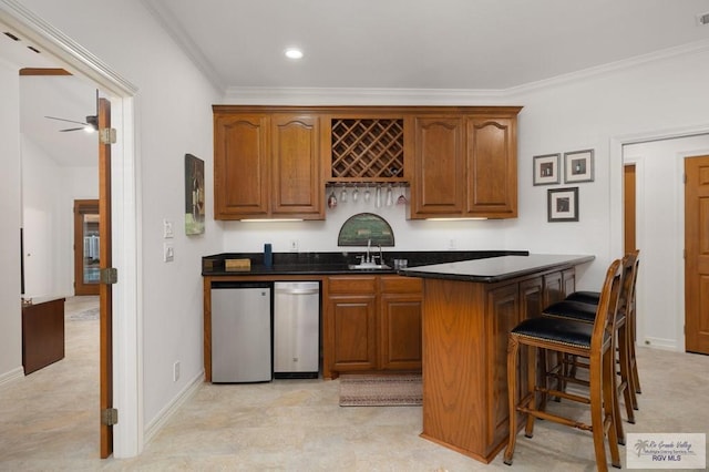 bar featuring ceiling fan, a sink, ornamental molding, fridge, and wet bar