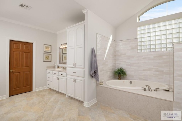 bathroom with visible vents, vanity, vaulted ceiling, ornamental molding, and a bath