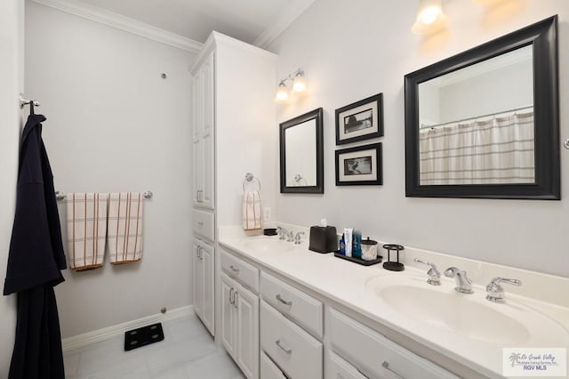 bathroom featuring double vanity, ornamental molding, a sink, and baseboards