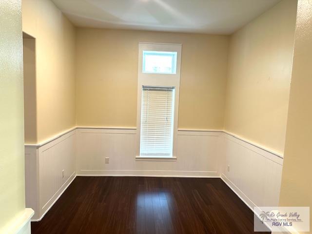 unfurnished room with dark hardwood / wood-style floors