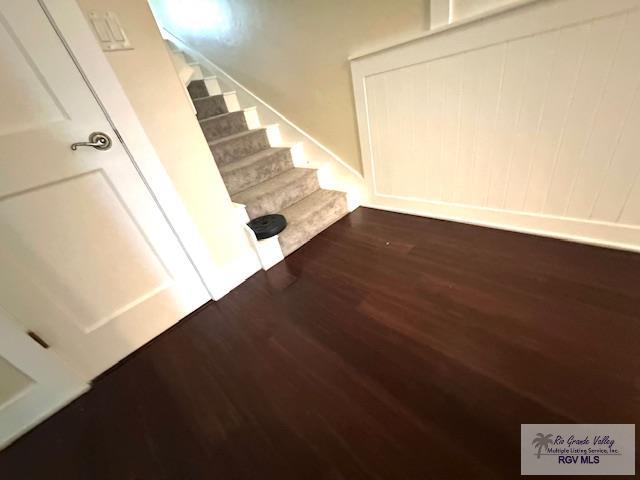 stairs featuring hardwood / wood-style floors