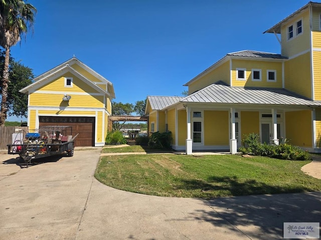 exterior space featuring a front yard, a garage, and covered porch