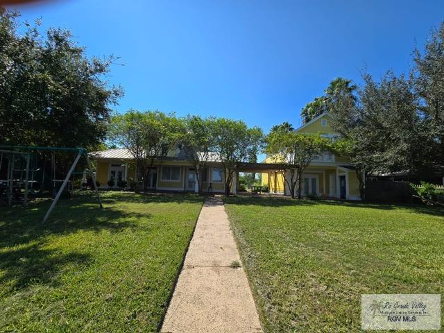 view of front of property with a playground and a front yard