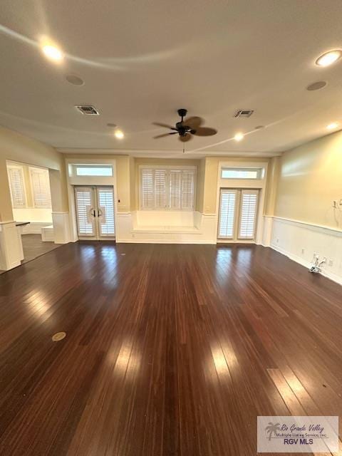 unfurnished living room featuring french doors, ceiling fan, and dark wood-type flooring