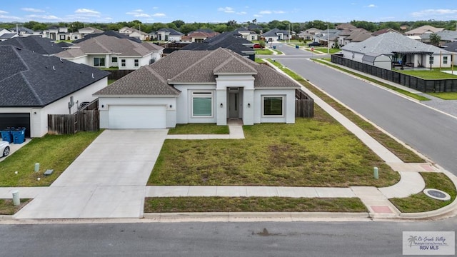 9372 Fan Palm Dr, Los Fresnos, TX 78521 - view of front of property with a residential view, a garage, driveway, stucco siding, and roof with shingles