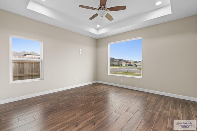 9372 Fan Palm Dr, Los Fresnos, TX 78521 - unfurnished room with a raised ceiling, dark wood-style floors, a ceiling fan, baseboards, and recessed lighting