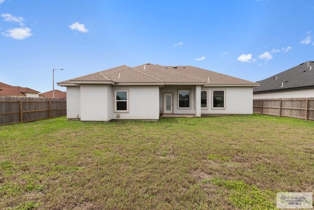 9372 Fan Palm Dr, Los Fresnos, TX 78521 - rear view of house with stucco siding and roof with shingles