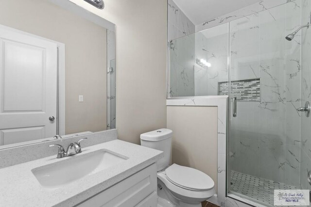 9372 Fan Palm Dr, Los Fresnos, TX 78521 - bathroom with a marble finish shower, toilet, and vanity