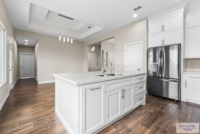 9372 Fan Palm Dr, Los Fresnos, TX 78521 - kitchen with stainless steel fridge, a sink, a tray ceiling, dark wood-style floors, and recessed lighting
