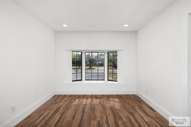 spare room featuring wood-type flooring