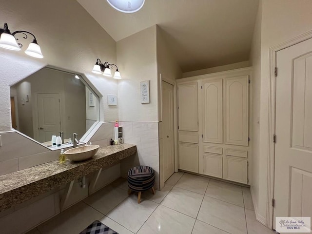 4870 Mckenzie Rd, Brownsville, TX 78521 - bathroom featuring tile patterned floors, a sink, and lofted ceiling