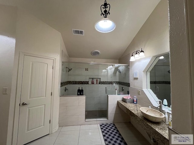 4870 Mckenzie Rd, Brownsville, TX 78521 - full bathroom featuring vaulted ceiling, a shower stall, tile patterned flooring, and vanity
