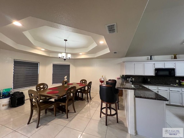 4870 Mckenzie Rd, Brownsville, TX 78521 - dining room with a raised ceiling, a chandelier, and light tile patterned floors