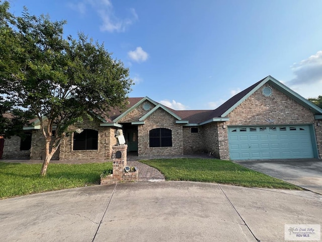4870 Mckenzie Rd, Brownsville, TX 78521 - single story home with driveway, an attached garage, a front lawn, and brick siding