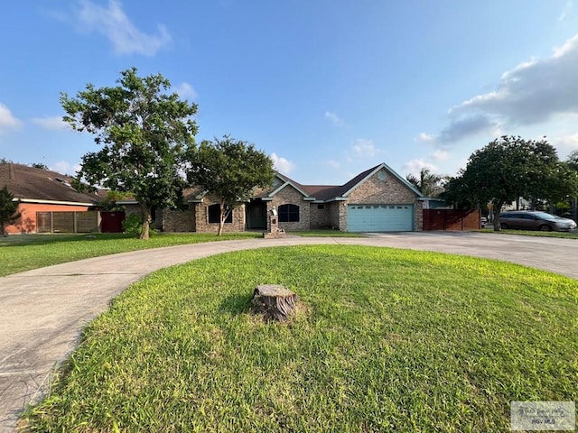4870 Mckenzie Rd, Brownsville, TX 78521 - ranch-style home featuring curved driveway, a front lawn, a garage, and brick siding