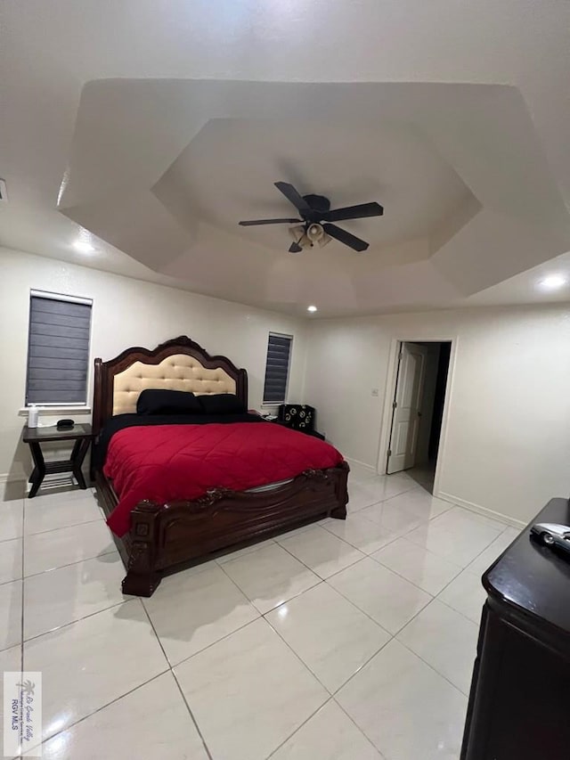 4870 Mckenzie Rd, Brownsville, TX 78521 - bedroom featuring baseboards, a tray ceiling, light tile patterned floors, and ceiling fan