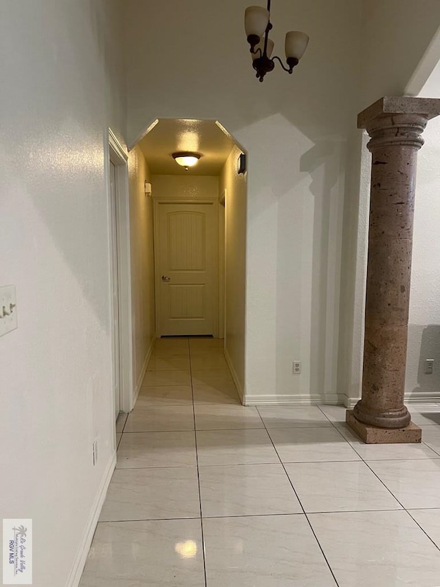 4870 Mckenzie Rd, Brownsville, TX 78521 - corridor featuring decorative columns, light tile patterned floors, and baseboards