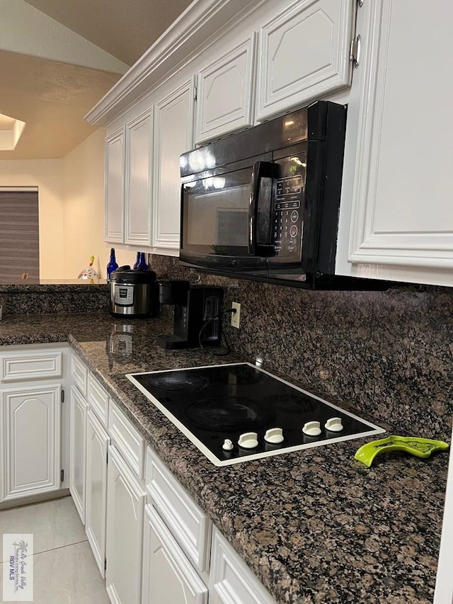 4870 Mckenzie Rd, Brownsville, TX 78521 - kitchen featuring black appliances, white cabinets, decorative backsplash, a peninsula, and dark stone counters