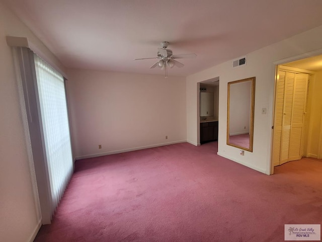 unfurnished bedroom featuring carpet flooring, a closet, ceiling fan, and ensuite bathroom