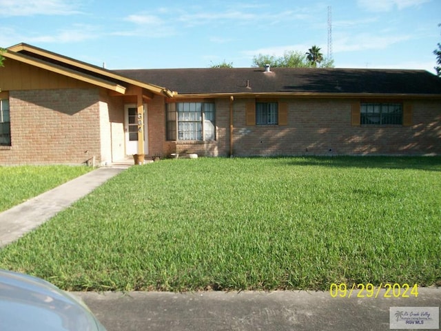 ranch-style home featuring a front yard