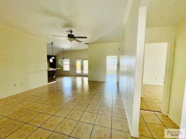 unfurnished room with ceiling fan and light tile patterned floors