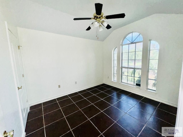 tiled spare room featuring ceiling fan and vaulted ceiling