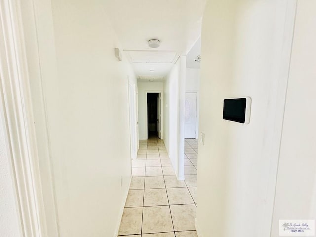 hall featuring light tile patterned flooring