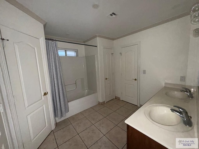 bathroom with shower / bath combo with shower curtain, vanity, ornamental molding, and tile patterned flooring