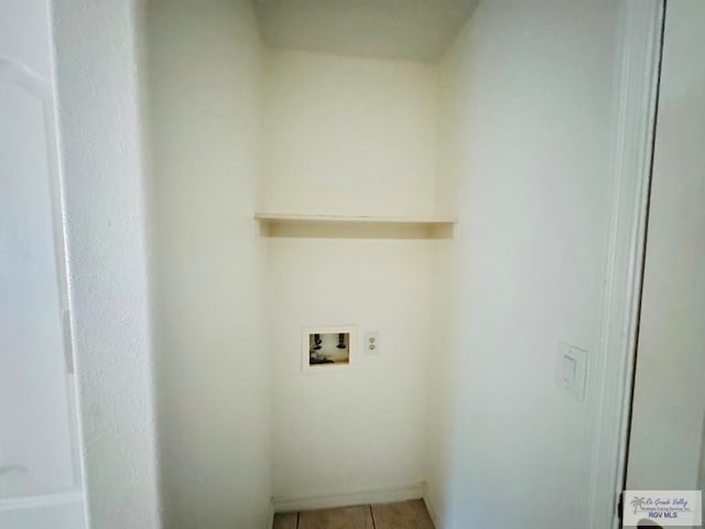 laundry area featuring light tile patterned floors and washer hookup