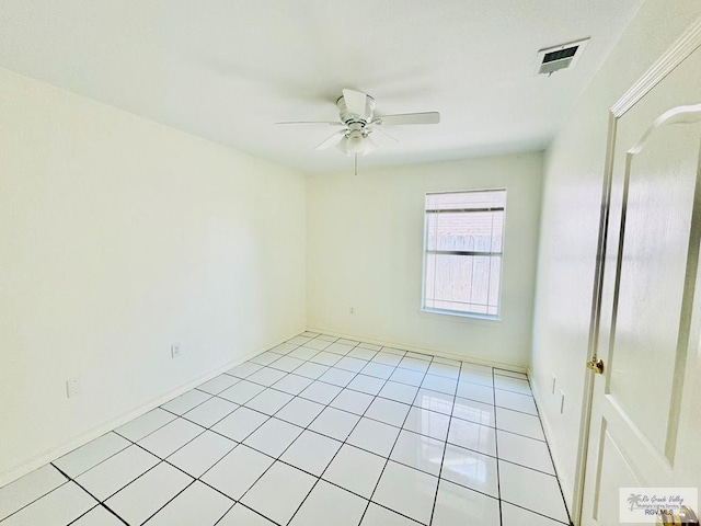 tiled spare room featuring ceiling fan