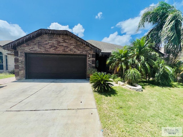 view of front facade with a front yard and a garage