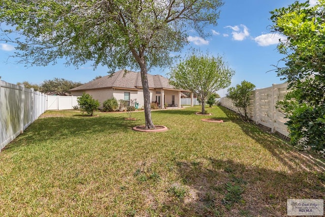 view of yard with a fenced backyard