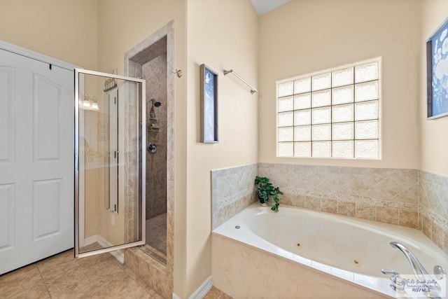 full bath with a tub with jets, a shower stall, and tile patterned floors