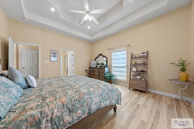 bedroom with baseboards, a raised ceiling, ceiling fan, wood finished floors, and recessed lighting