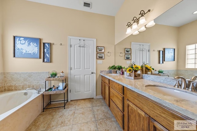 bathroom featuring double vanity, visible vents, a garden tub, tile patterned flooring, and a sink